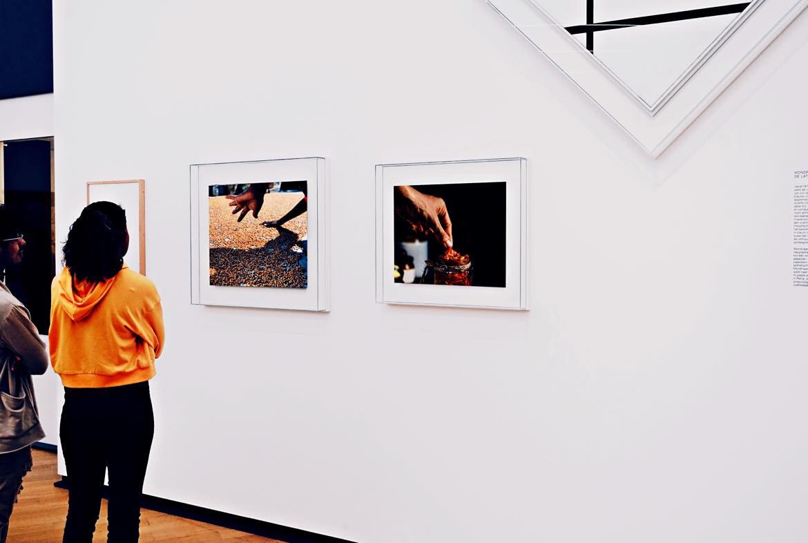 A visitor looking at photographs in an Amsterdam gallery